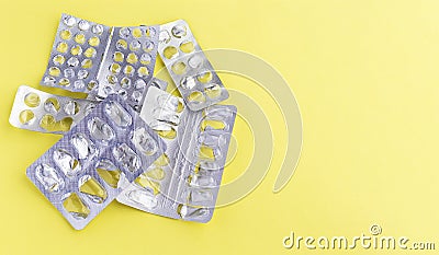 Empty blister packs from tablets on a yellow background. The packaging of the tablets. Copyspase Stock Photo