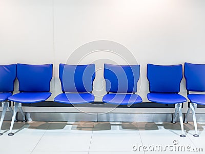 Empty blue leather airport seats on white background Stock Photo