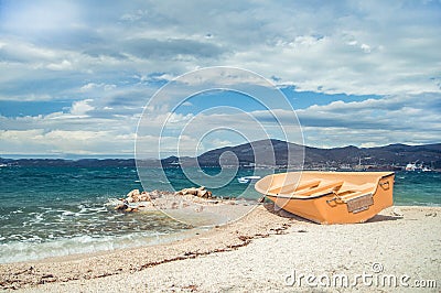 Empty boat on stony beach Stock Photo