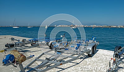 Empty boat trailer on the pier at the harbor in summer day Stock Photo
