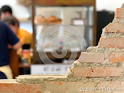 Empty bricks wall with blurred cafe background. Stock Photo