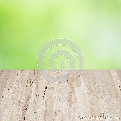 Empty brown wooden table in front of abstract blurred bokeh background of green nature outoor. Stock Photo