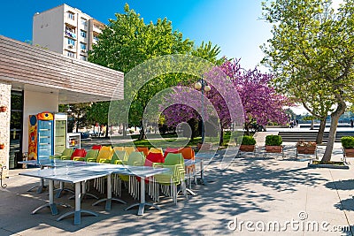 Empty cafe in the early morning, city park at spring time Editorial Stock Photo