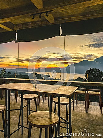 Empty cafe on sunrise with view on Batur volcano Stock Photo