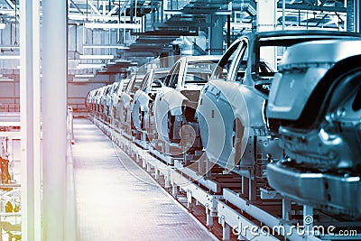 Car bodies are on Assembly line. Factory for production of cars in blue. Modern automotive industry. Blue tone Stock Photo