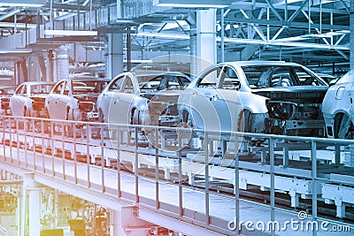 Car bodies are on Assembly line. Factory for production of cars in blue. Modern automotive industry. Blue tone Stock Photo