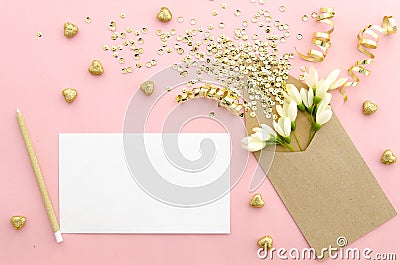 Empty card with envelope, glitter sequins, confetti, hearts and flowers on a gently pink backgroundgold. Mock up Stock Photo