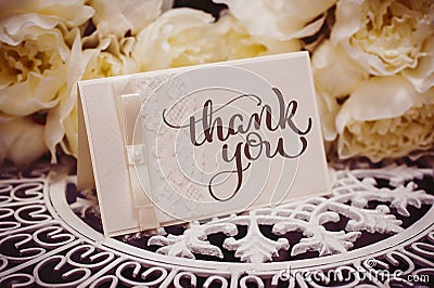 Empty card to place text surrounded by flowers with text Thank you. Calligraphy lettering hand draw Stock Photo