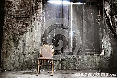 Empty chair and grungy wall Stock Photo