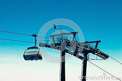 Empty chair ski lift over blue sky in the evening Stock Photo