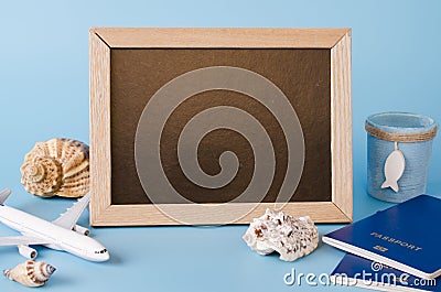 Empty chalkboard with decorative airplane, passports and seashells . Summer travel concept Stock Photo