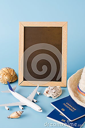 Empty chalkboard with decorative airplane, passports and seashells . Summer travel concept Stock Photo