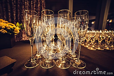 Empty champagne glasses in row on evening event party waiting for the guests. Stock Photo