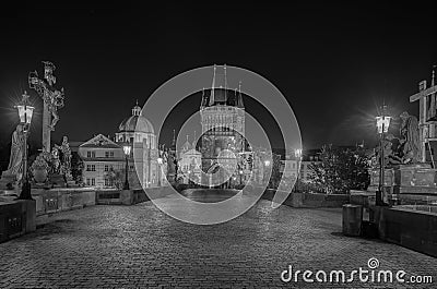 Empty Charles Bridge in the center of Prague during first wave of Covid-19 pandemy in the night with blue sky and yello Stock Photo