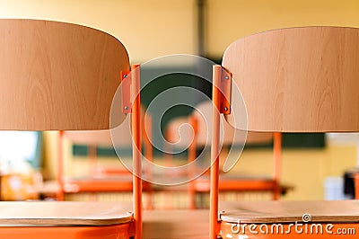 Empty classroom with school desks, chairs and blackboard. Stock Photo