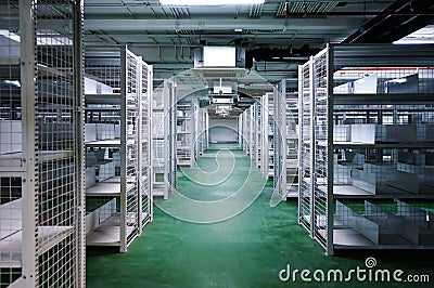 Empty and clean white steel shelf and grill in the basement green floor Stock Photo