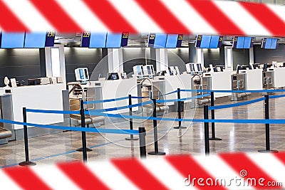 Empty closed airport terminal check-in hall with warning tape. Covid-19 quarantine Stock Photo
