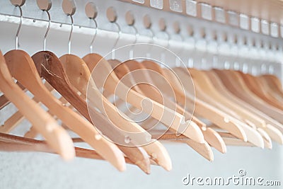 Empty clothes hangers lined up in a room Stock Photo