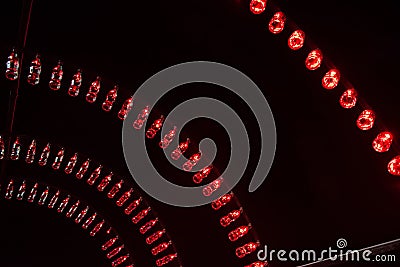 Empty Coca Cola bottles are arranged and illuminated with red li Editorial Stock Photo