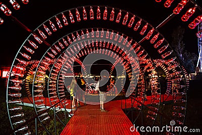 Empty Coca Cola bottles are arranged and illuminated with red li Editorial Stock Photo