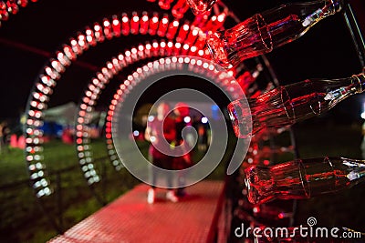 Empty Coca Cola bottles are arranged and illuminated with red li Editorial Stock Photo