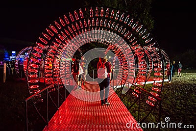 Empty Coca Cola bottles are arranged and illuminated with red li Editorial Stock Photo