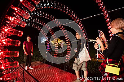 Empty Coca Cola bottles are arranged and illuminated with red li Editorial Stock Photo