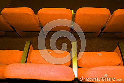 Empty concert hall, theater chairs background ... color photo, empty cinema or concert hall. The red chairs in the Stock Photo