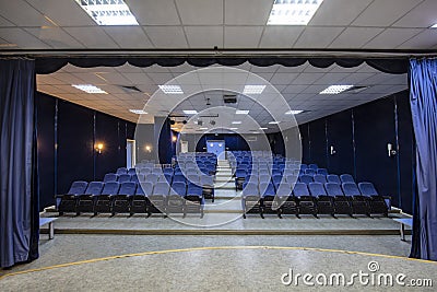 Empty conference,theater or cinema hall with rows of blue seats Stock Photo