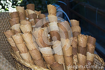 Empty cornets to contain fried food on a hamper with a chair Stock Photo