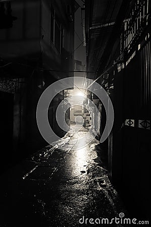 Empty and dangerous looking urban back-alley at night time in suburbs Hanoi Stock Photo