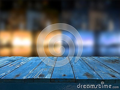 Empty dark blue wooden table in front of abstract blurred blur background of restaurant. Can be used for display or montage your Stock Photo