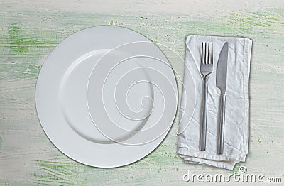 Empty dish and cutlery on green white wood Stock Photo