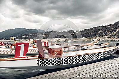 Empty dragon boats ready for race. Tinted photo Stock Photo