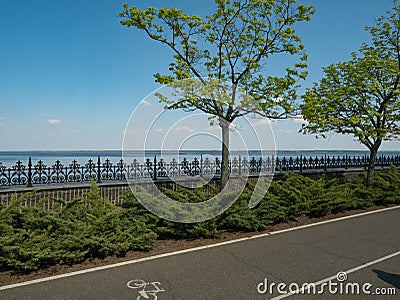 Empty embankment with bike lane green trees Stock Photo