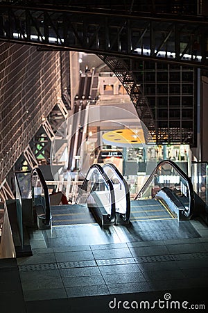 Empty escalator in Japanese shopping center of Kyoto railway station. High point of building at evening time. Japan Stock Photo
