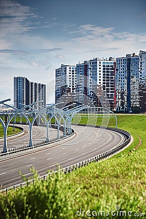 Empty expressway of the western high-speed diameter in st. petersburg in clear sunny weather, green lawns along the road Stock Photo