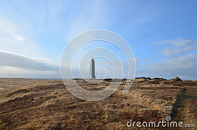 Empty Field with Malarrif Lighthouse in Iceland Stock Photo