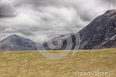 Empty field and three hills Stock Photo