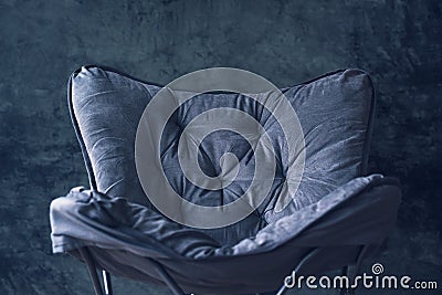 Empty foldable chair against gray wall Stock Photo