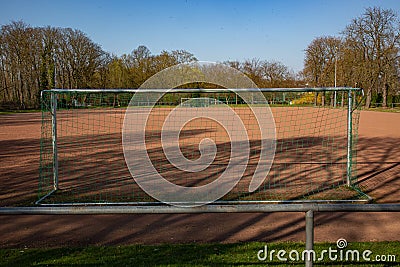 Empty football field in the sun based on championship interruption because of corona Stock Photo