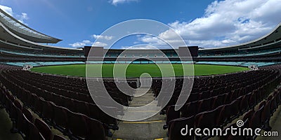 Empty football stadium with green grass and blue sky, nobody soccer field Stock Photo