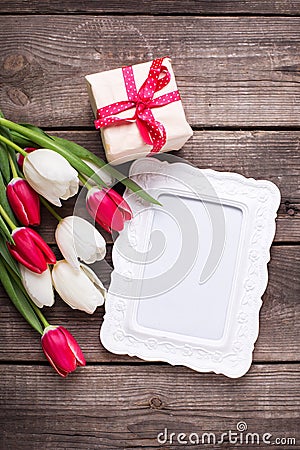 Empty frame, box with present and bright tulips flowers Stock Photo