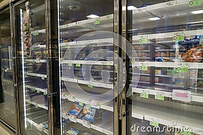 Empty freezer shelves at Publix featuring frozen food shortage including organic vegetables, pizza, and junk food during Covid-19 Editorial Stock Photo