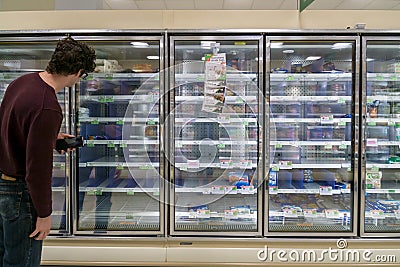 Empty freezer shelves at Publix featuring frozen food shortage including organic vegetables, pizza, and junk food during Covid-19 Editorial Stock Photo