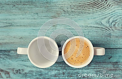 Empty and full cup of fresh coffee on vintage blue table Stock Photo