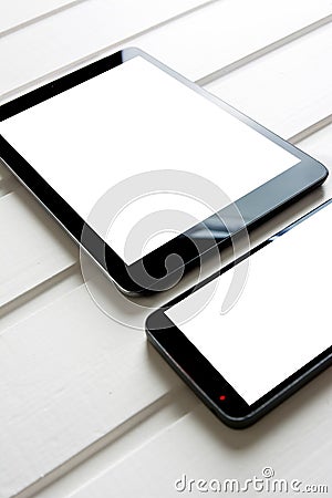 Empty generic tablet pc and mobile on top of white wood Stock Photo
