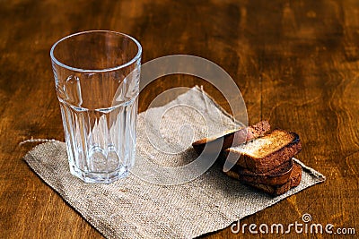 Empty glass with black rye bread and hard chucks Stock Photo