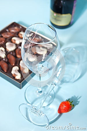 Empty glasses for champagne or wine. box of chocolates and bottle on the background Stock Photo