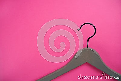 Empty gray clothes hanger on bright pink background. Stock Photo